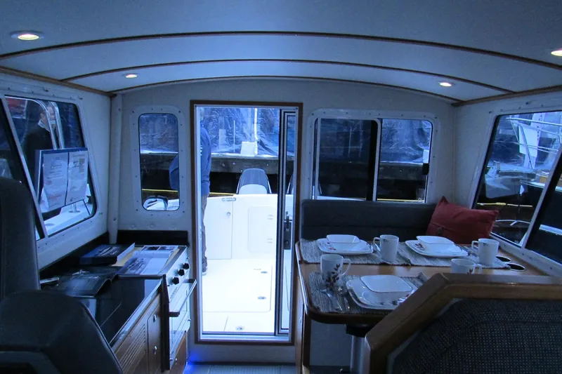Slide: The Image of Interior of 2026 Sea Sport Voyager 3000 boat with dining area and helm. - 5
