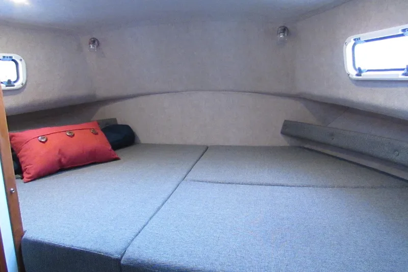 Slide: The Image of Cozy cabin interior of 2026 Sea Sport Voyager 3000 with plush bedding and porthole windows. - 6