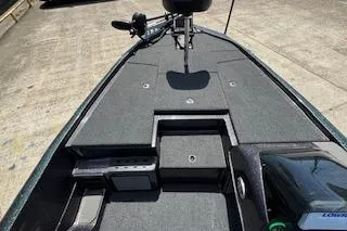 Slide: The Image of 2026 Blazer 595 Pro Elite boat deck with storage compartments and trolling motor. - 16