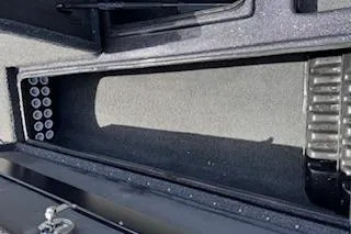 Slide: The Image of Storage compartment of 2026 Blazer 595 Pro Elite boat, featuring organized slots. - 17