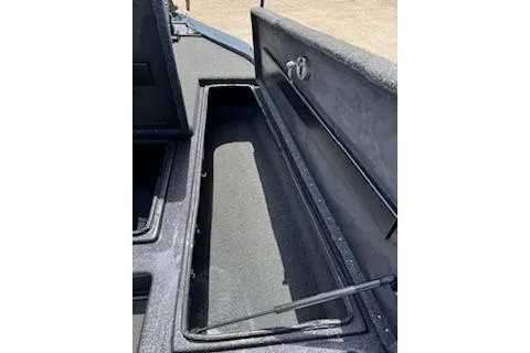 Slide: The Image of Open storage compartment in 2026 Blazer 595 Pro Elite boat. - 19