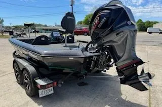 Slide: The Image of 2026 Blazer 595 Pro Elite boat with powerful outboard motor on trailer. - 2