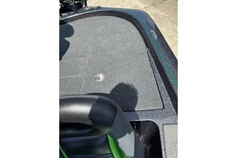 Slide: The Image of 2026 Blazer 595 Pro Elite boat interior with gray carpet and black-green seating. - 22