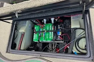 Slide: The Image of 2026 Blazer 595 Pro Elite boat battery compartment with wiring and components. - 26