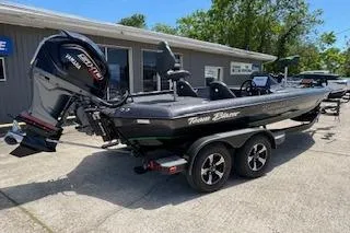 Slide: The Image of 2026 Blazer 595 Pro Elite boat with powerful engine, parked outdoors on a sunny day. - 4