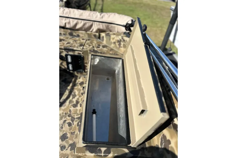 Slide: The Image of Open storage compartment on 2026 Excel 1751 Viper F4 boat with camouflage pattern. - 11