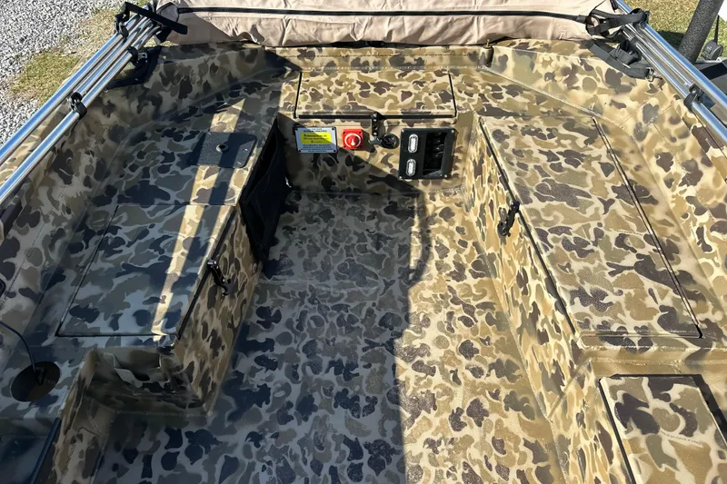 Slide: The Image of Camouflage interior of 2026 Excel 1751 Viper F4 boat, featuring storage compartments and control panel. - 16