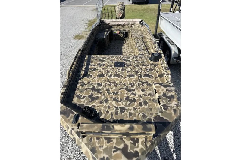 Slide: The Image of Camouflage-patterned Excel 1751 Viper F4 boat, 2026 model, parked on gravel. - 17