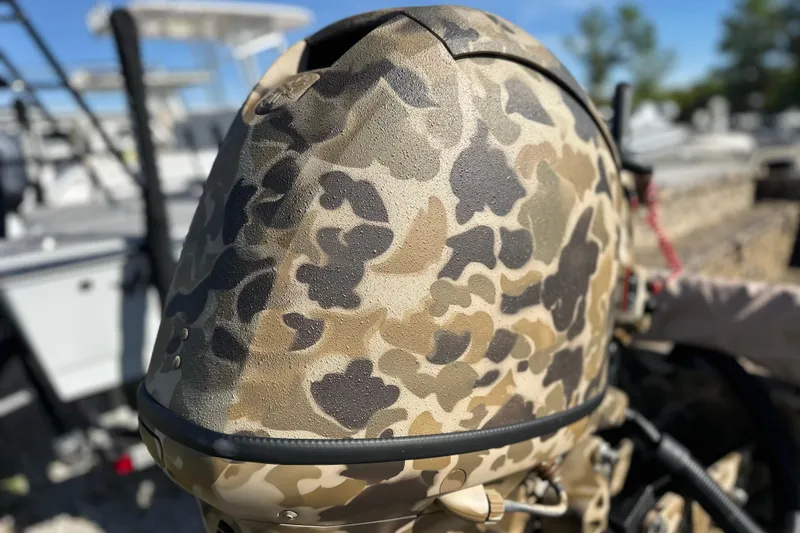 Slide: The Image of Camouflage-patterned engine cover of 2026 Excel 1751 Viper F4 boat, outdoors. - 2