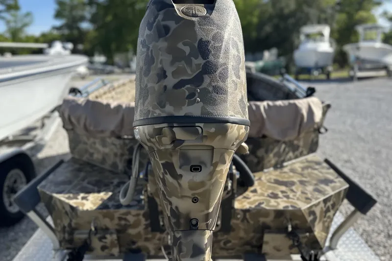 Slide: The Image of Camouflage-patterned Excel 1751 Viper F4 boat motor, 2026 model, in a marina setting. - 20