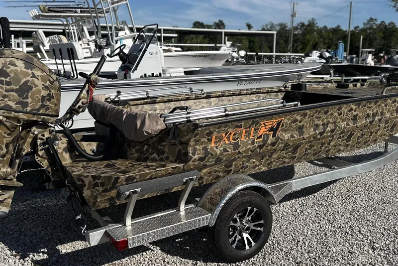 Slide: The Image of Camouflage-patterned Excel 1751 Viper F4 boat on trailer, 2026 model, parked outdoors. - 22