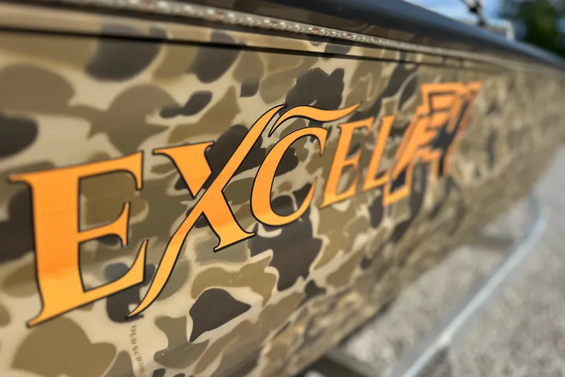 Slide: The Image of Camouflage-patterned Excel 1751 Viper F4 boat with bold orange lettering, 2026 model. - 3