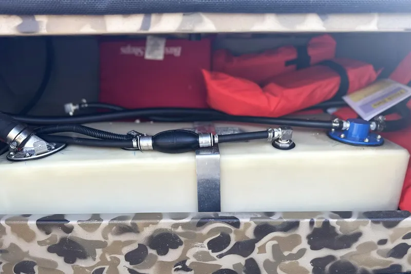 Slide: The Image of Camouflage storage compartment in 2026 Excel 1751 Viper F4 with fuel tank and safety gear. - 8