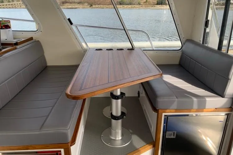 Slide: The Image of Interior of 2026 Sea Sport Pacific 3200 boat with seating and table. - 14