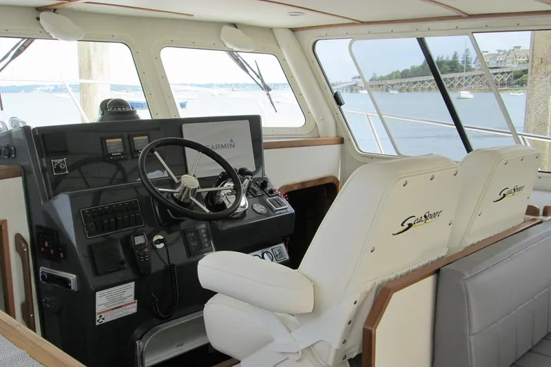 Slide: The Image of Interior of 2026 Sea Sport Pacific 3200 boat with steering wheel and navigation equipment. - 15