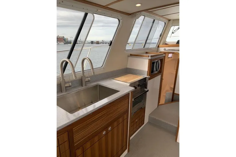 Slide: The Image of Interior of 2026 Sea Sport Pacific 3200 boat featuring modern kitchen amenities. - 18