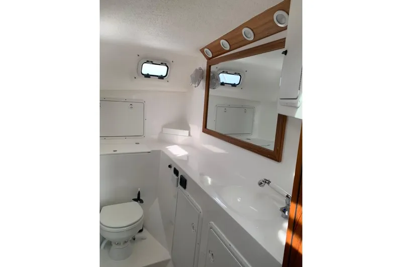 Slide: The Image of Interior of 2026 Sea Sport Pacific 3200 boat bathroom with mirror and porthole. - 19