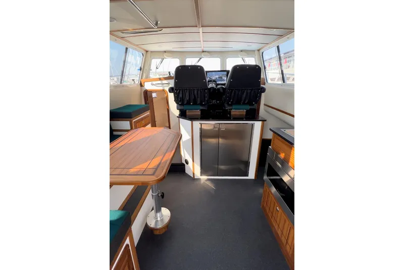 Slide: The Image of Interior of 2026 Sea Sport Pacific 3200 boat with seating and navigation area. - 22