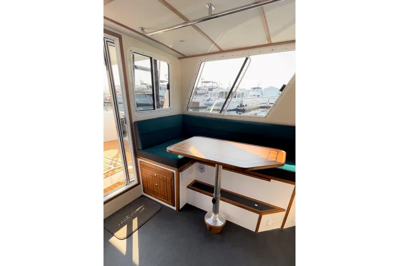 Slide: The Image of Interior of 2026 Sea Sport Pacific 3200 boat with seating and table. - 25