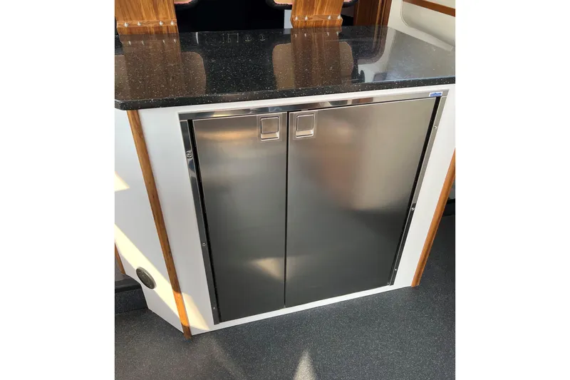 Slide: The Image of Stainless steel cabinet with black countertop on 2026 Sea Sport Pacific 3200 boat. - 26