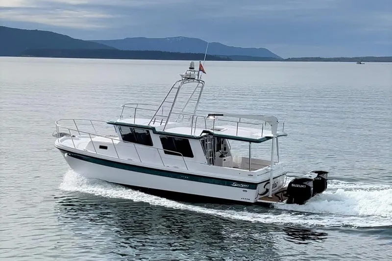 Slide: The Image of 2026 Sea Sport Pacific 3200 cruising on calm waters with scenic mountain backdrop. - 29