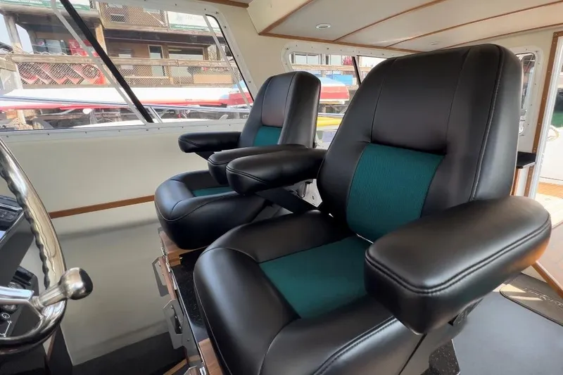 Slide: The Image of Interior of 2026 Sea Sport Pacific 3200 with luxurious black and teal seating. - 4