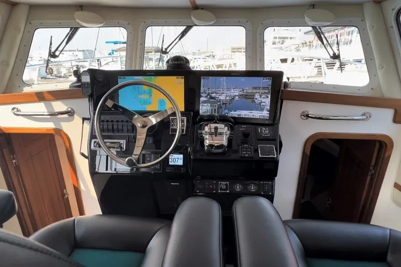 Slide: The Image of Interior helm of 2026 Sea Sport Pacific 3200 boat with modern navigation equipment. - 5