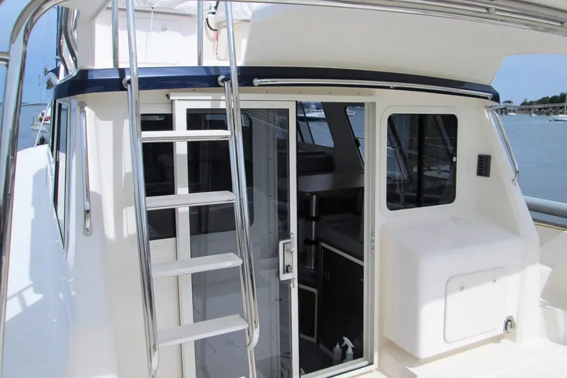 Slide: The Image of Sea Sport Pacific 3200 boat, 2026 model, featuring a sleek exterior with ladder and sliding door. - 9