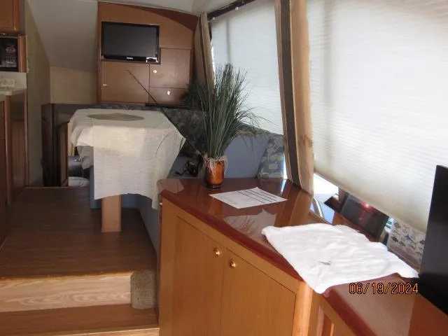 Slide: The Image of Interior of 2004 Ocean Yachts Super Sport with dining area and TV. - 10