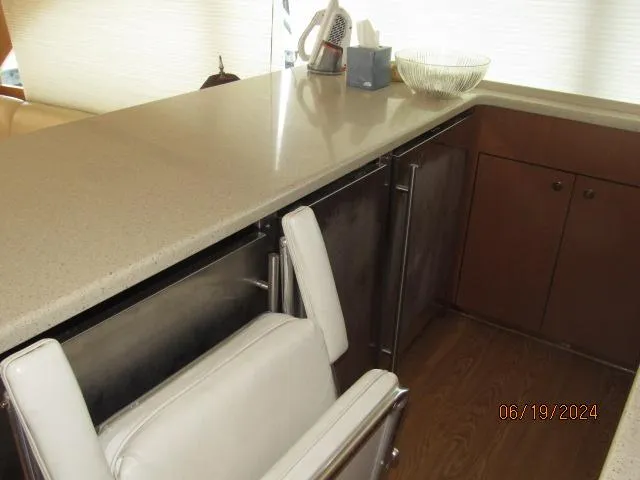 Slide: The Image of Ocean Yachts 2004 Super Sport kitchen area with countertop and built-in appliances. - 17