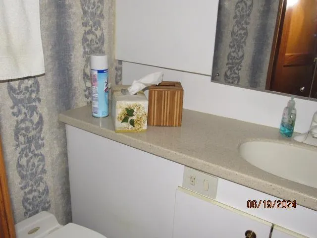 Slide: The Image of Bathroom vanity in a 2004 Ocean Yachts Super Sport boat with toiletries and tissue box. - 21