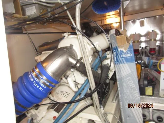 Slide: The Image of Engine room of a 2004 Ocean Yachts Super Sport boat with various mechanical components. - 26