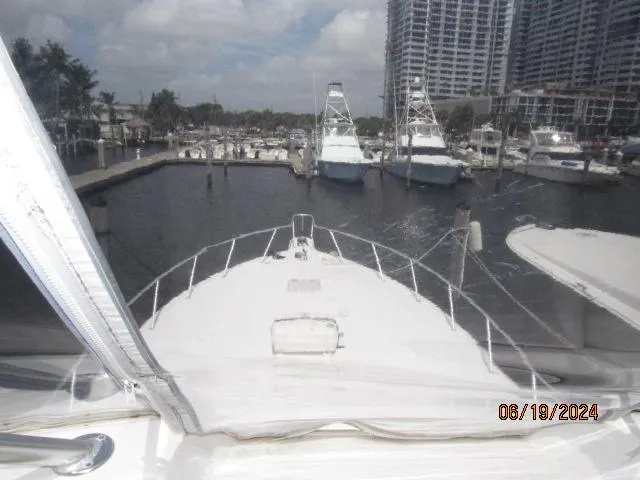 Slide: The Image of View from the bow of a 2004 Ocean Yachts Super Sport docked at a marina. - 6