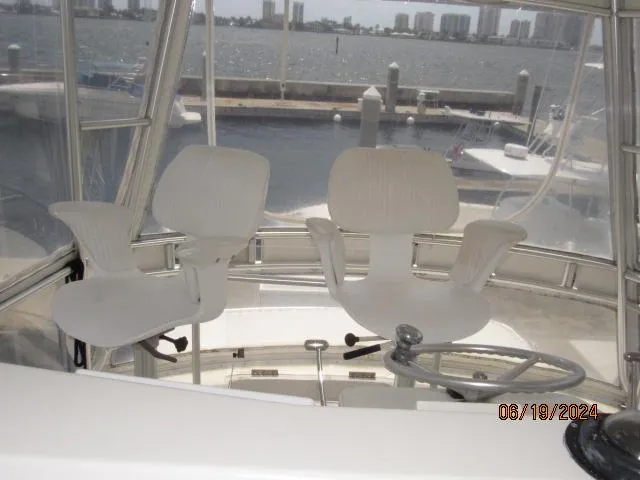 Slide: The Image of 2004 Ocean Yachts Super Sport helm with two white captain chairs. - 8