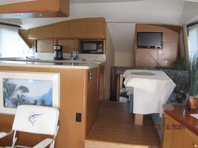 Slide: The Image of Interior of 2004 Ocean Yachts Super Sport with kitchen and dining area. - 9