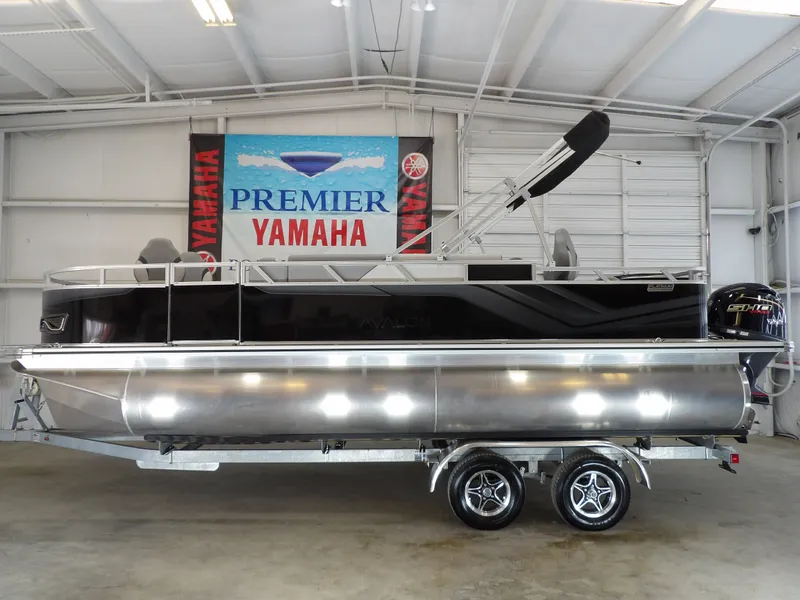 Slide: The Image of 2026 Avalon Venture 85 pontoon boat in a showroom. - 12