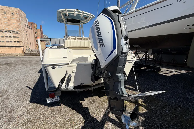 Slide: The Image of 2017 Sea Chaser 24 HFC boat with Evinrude 300 outboard motor in a marina. - 10