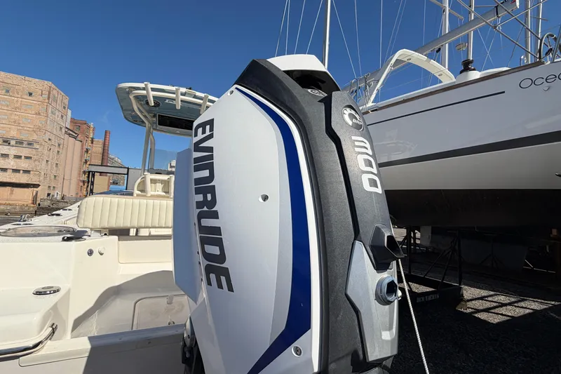 Slide: The Image of 2017 Sea Chaser 24 HFC boat with Evinrude 300 engine, docked near industrial buildings. - 11