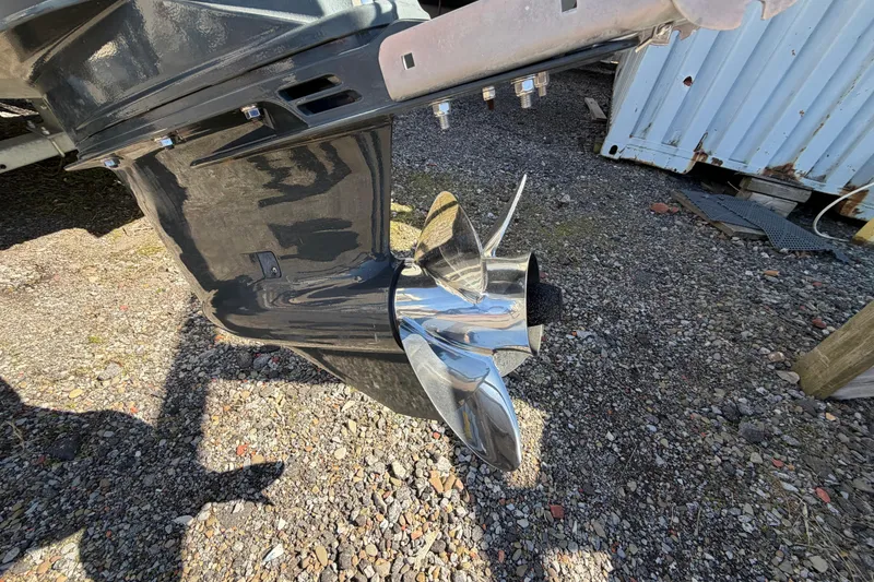 Slide: The Image of 2017 Sea Chaser 24 HFC boat propeller on gravel surface, showcasing shiny metal finish. - 13