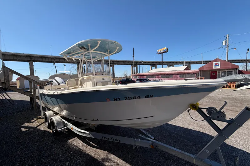 Slide: The Image of 2017 Sea Chaser 24 HFC boat on trailer, parked outdoors under clear sky. - 19