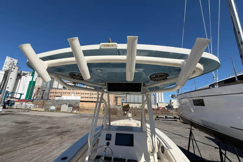 Slide: The Image of 2017 Sea Chaser 24 HFC boat with T-top and rod holders, docked in a marina. - 26