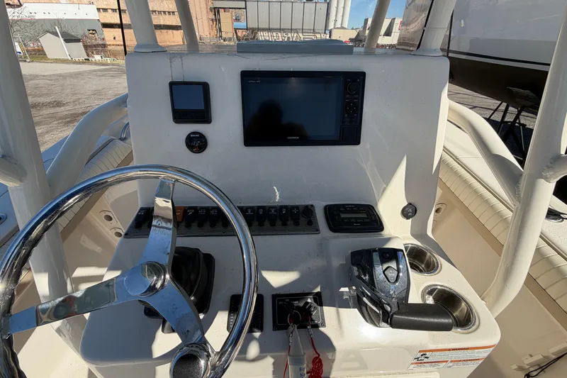 Slide: The Image of 2017 Sea Chaser 24 HFC boat dashboard with steering wheel and navigation controls. - 30