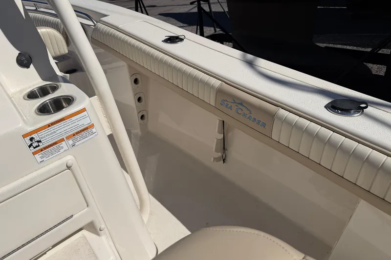 Slide: The Image of 2017 Sea Chaser 24 HFC boat interior with cup holders and branding. - 50