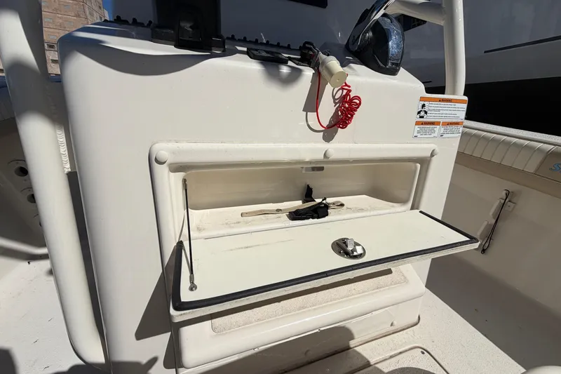 Slide: The Image of 2017 Sea Chaser 24 HFC boat console with open storage compartment and safety equipment. - 53