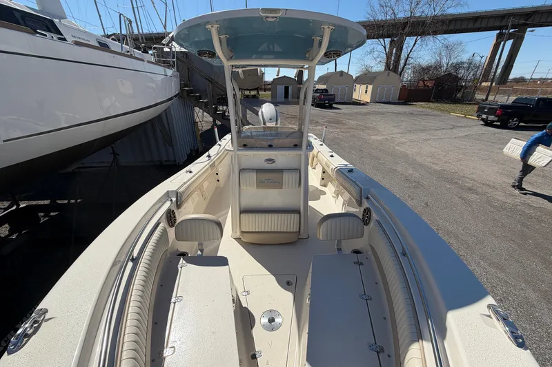 Slide: The Image of 2017 Sea Chaser 24 HFC boat with spacious deck and seating, docked near other vessels. - 59