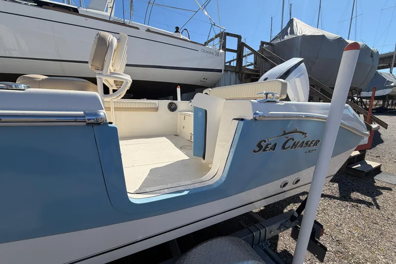 Slide: The Image of 2017 Sea Chaser 24 HFC boat on trailer, docked in a marina. - 6