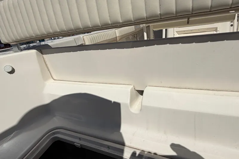 Slide: The Image of 2017 Sea Chaser 24 HFC boat interior with white seating and storage compartment. - 60