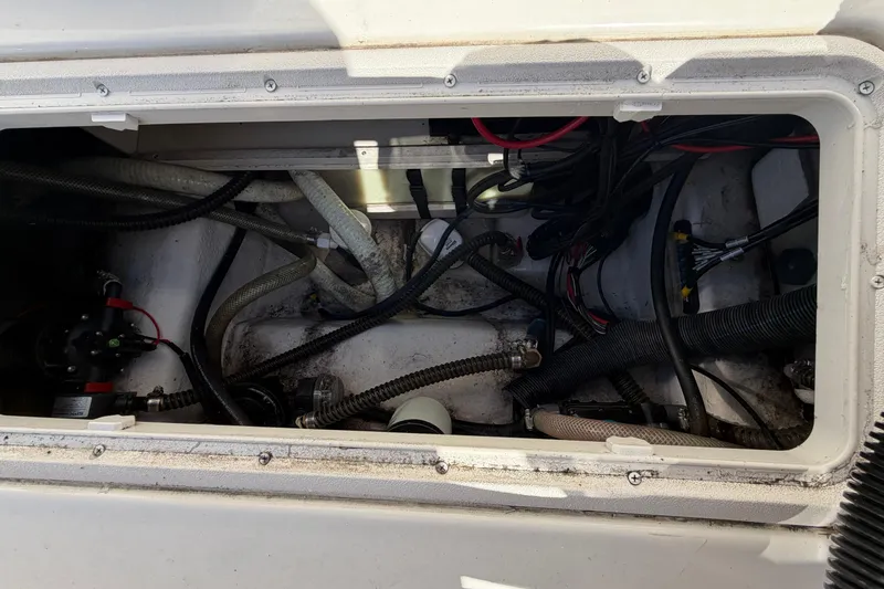 Slide: The Image of 2017 Sea Chaser 24 HFC boat compartment with wiring and hoses visible. - 61
