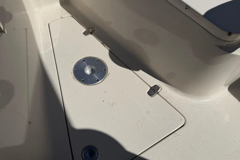 Slide: The Image of 2017 Sea Chaser 24 HFC boat deck with storage compartment and metal fixture. - 63