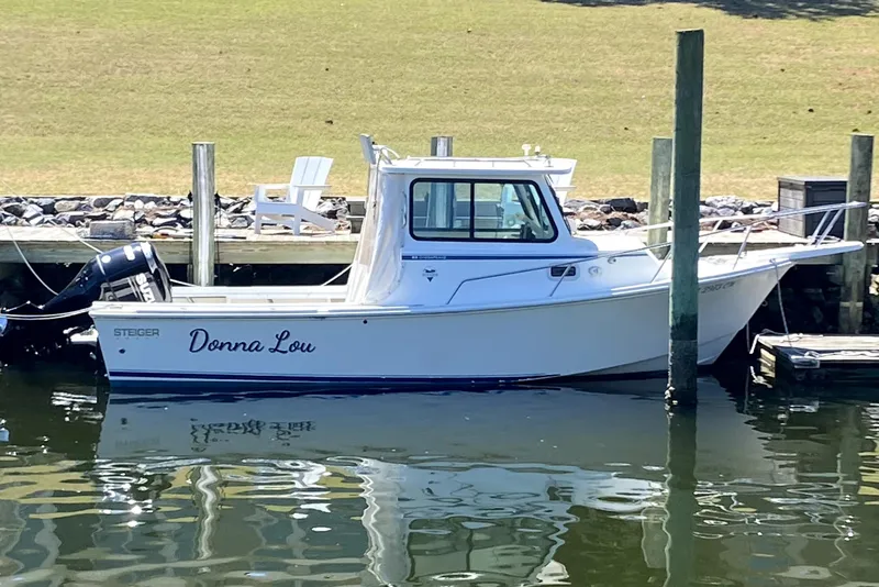 The Image of 2005 Steiger Craft 23 Miami boat named "Donna Lou" docked by the water. - 0